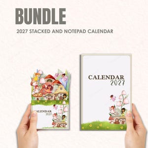 May include: A bundle of 2027 calendars. One is a stacked calendar with a fairy village design, the other is a notepad calendar. The stacked calendar features mushroom houses and fairies. The notepad calendar has a similar design.