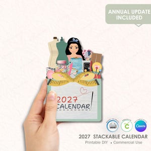 May include: A 2027 calendar featuring a cartoon illustration of a person surrounded by sewing supplies including mannequins, a jar of buttons, thread spools, and a measuring tape. The calendar has a light green border and a needle and thread graphic.