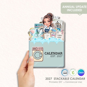 May include: A light blue 2027 stackable calendar with a laundry theme. The calendar features a cartoon illustration of a woman, a washing machine, and laundry supplies. Text includes "CALENDAR EST. 2027" and "ANNUAL UPDATE INCLUDED."