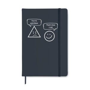 May include: A dark blue notebook with a black elastic band and a bookmark. The cover features a white triangle with an angry face and the text "You're pointless" in a speech bubble. A smiling face and the text "That's how I roll" are also on the cover.