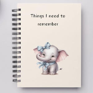 May include: A spiral bound notebook with a cream cover featuring the text "Things I need to remember" and a cartoon illustration of a smiling elephant with a blue bow and a blue ribbon around its neck.