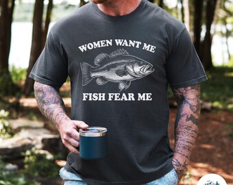 May include: A dark gray t-shirt with a white graphic of a fish and the text "Women Want Me Fish Fear Me".