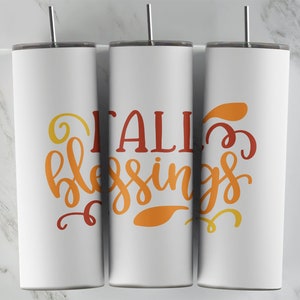 May include: Three white tumblers with a fall-themed design. The tumblers have a red, orange, and yellow gradient with the text "Fall Blessings" in a stylized font.