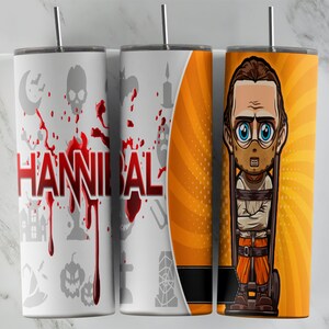 May include: Three stainless steel tumblers with different designs. The first tumbler has a white background with red blood splatters and the word "HANNIBAL" in red. The second tumbler has an orange background with a black spiderweb design. The third tumbler has an orange background with a cartoon image of a man with a mask and a straitjacket.