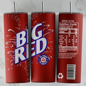 May include: A red and white tumbler with the words "Big Red" in a white font. The tumbler has a red background with white bubbles and a splash of red liquid. The text "So Sweet" and "So Smooth" are printed in white on a red circle. The text "Est. 1937" is printed in white below the circle. The tumbler has a nutrition facts label on the side with the text "Contains Caffeine".