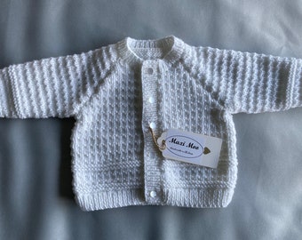 Hand knit baby cardigan with decorative buttons