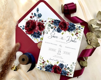May include: Save the Date card with watercolor floral design in shades of burgundy and blue. The card features the text "Save the Date" in a cursive font, followed by the names "Alison Williams" and "Martin Smith". The date is August 25th, 20XX at 10 AM. The card also includes the address "Jore Lane Lang, Hearteville NY 11" and the text "formal invitations to follow".
