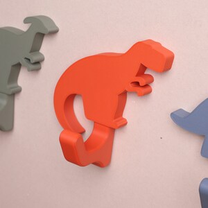 close up of dinosaur wall hooks