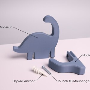 package contents - a blue dinosaur, wall hook, mounting screw, wall anchor