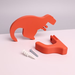 package contents - a red dinosaur, wall hook, mounting screw, wall anchor