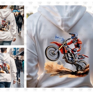 May include: White hoodie with a graphic print of a person riding a dirt bike. The dirt bike is orange and red with black wheels. The person is wearing a blue and red helmet and a red and white racing suit.
