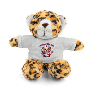 May include: A plush leopard-print teddy bear wearing a gray t-shirt with the text "Answer The Call" and a cartoon nurse bear graphic. The bear has a brown nose and white accents.