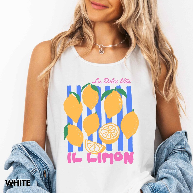 May include: White tank top with a graphic of yellow lemons, blue stripes, and the text "La Dolce Vita" and "Il Limon" in pink. The shirt is sleeveless.