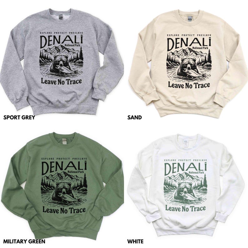 May include: Five crewneck sweatshirts in different colors: sport grey, sand, military green, white, and black. Each sweatshirt features a graphic print of a bear in a forest with the text "Explore Protect Preserve Denali National Park Leave No Trace".