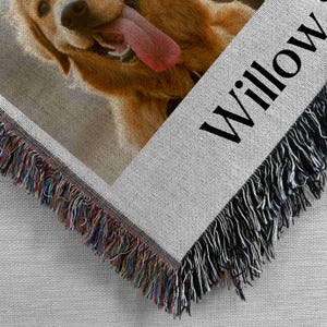 May include: A woven throw blanket with a photo of a golden retriever dog with its tongue sticking out. The blanket has a fringe border and the name "Willow" is printed on the bottom right corner.