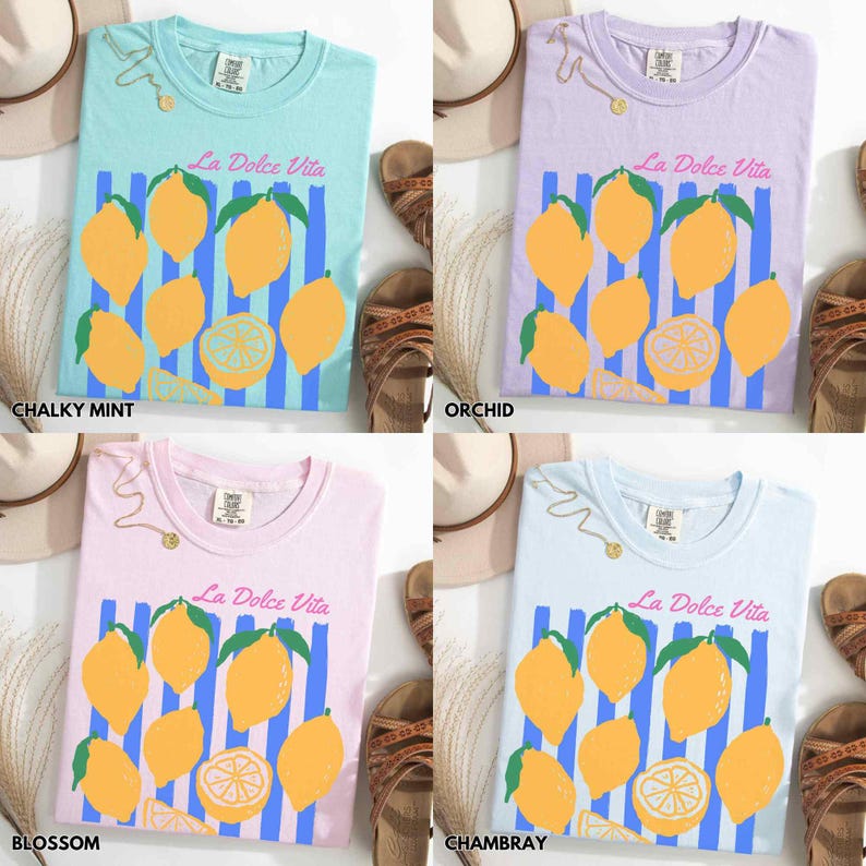 May include: Four pastel-colored t-shirts with the text "La Dolce Vita" and a lemon graphic. The shirts are in chalky mint, orchid, blossom, and chambray colors. Each shirt has a different background color and a similar design of lemons and blue stripes.