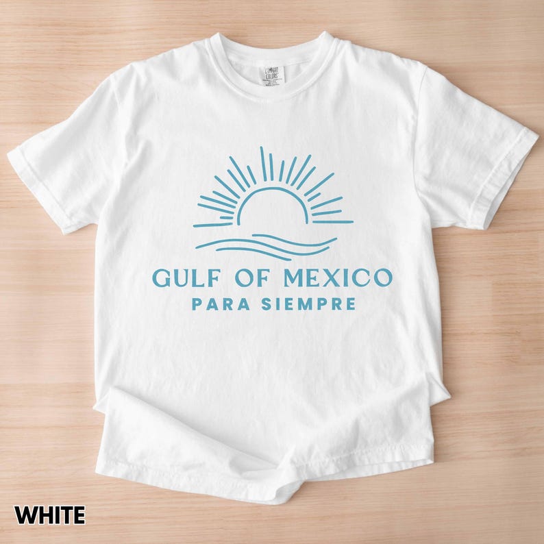 May include: White t-shirt with a blue graphic of a sun rising over waves and the text "GULF OF MEXICO PARA SIEMPRE".