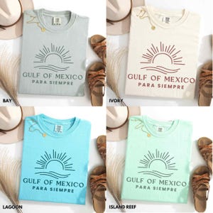 May include: Four different color t-shirts with a graphic design of a sun setting over a wave with the text "Gulf of Mexico Para Siempre". The colors are bay, ivory, lagoon, and island reef.