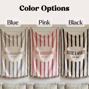 May include: Three personalized throw blankets with vertical stripe designs in blue, pink, and black. Each blanket features a family name and established year. The text "Color Options" is at the top.