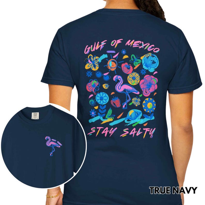 May include: A navy blue t-shirt with a colorful graphic print of a flamingo, flowers, and the text "Gulf of Mexico Stay Salty".