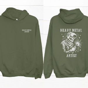 May include: A green hooded sweatshirt with the text "Heavy Metal Artist" on the front and a graphic of a skeleton welding with the same text on the back.