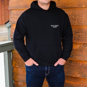 May include: A black hooded sweatshirt with the text "Heavy Metal Artist" printed on the front.