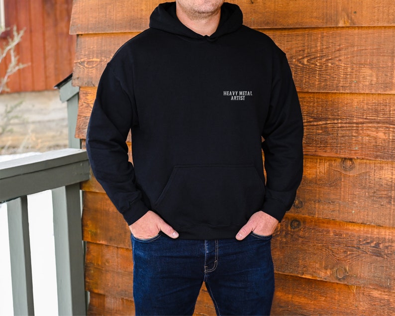 May include: A black hooded sweatshirt with the text "Heavy Metal Artist" printed on the front.