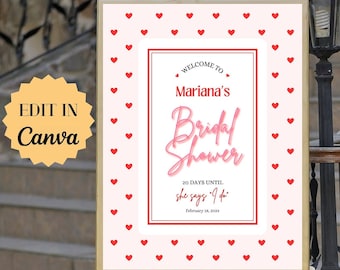 Könnte beinhalten: Ein weißes Schild mit rotem Herzrand und dem Text "Willkommen zu Marianas Bridal Shower 20 Tage bis sie 'Ja' sagt' 14. Februar 2024" auf einem weißen Staffelei.