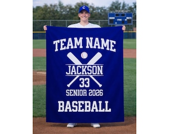 May include: A blue baseball banner with white text. The banner reads "TEAM NAME" at the top, with crossed baseball bats and a baseball in the center. Below, it says "JACKSON 33 SENIOR 2026 BASEBALL".