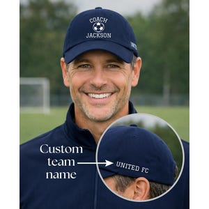 Soccer coach gift embroidered soccer hat with coach and the custom name written on the front of the hat with an embroidered soccer ball. And on the left side of the hat is the personalized team name.