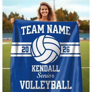 Senior Volleyball Gift Personalized Volleyball Blanket with the custom team name and volleyball written at the top and bottom respectively, along with a volleyball illustration in the center with the year on each side, and the personalized volleyball player name below it, with senior written below the name.