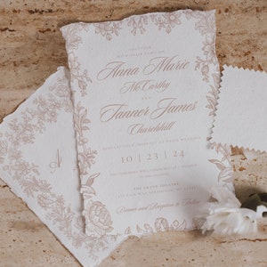 May include: A wedding invitation with a floral border and the text "Together with their families, Anna Marie McCarthy and Tanner James Churchill, request your presence at their wedding, 10 | 23 | 24. The ceremony will commence at 2 o'clock in the evening, The Grand Theatre, 1st Fair Way Springston, ME 12345. Dinner and Reception to follow."