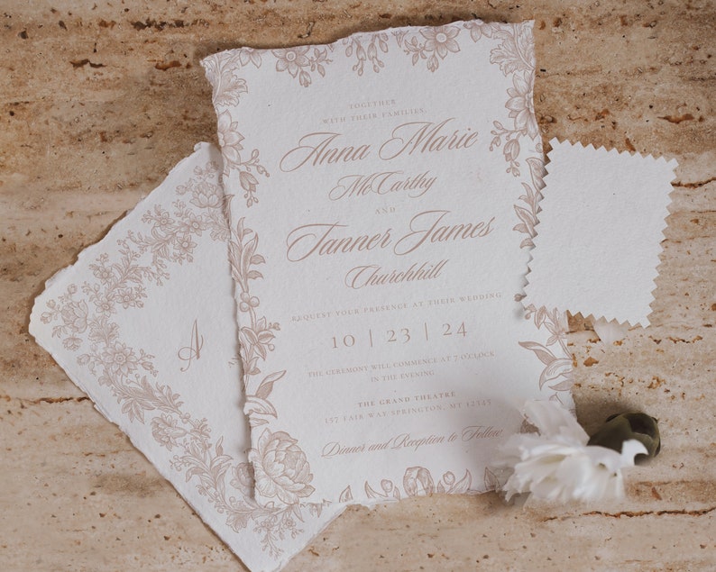 May include: A wedding invitation with a floral border and the text "Together with their families, Anna Marie McCarthy and Tanner James Churchill, request your presence at their wedding, 10 | 23 | 24. The ceremony will commence at 2 o'clock in the evening, The Grand Theatre, 1st Fair Way Springston, ME 12345. Dinner and Reception to follow."