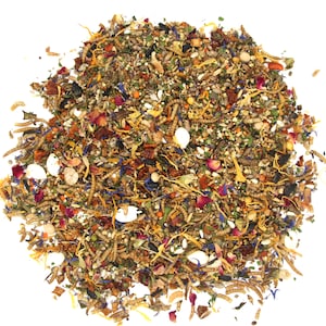 May include: A close-up of a mixture of dried food for small animals, including insects, seeds, and flowers. The mixture is a variety of colors, including brown, yellow, orange, red, and blue.
