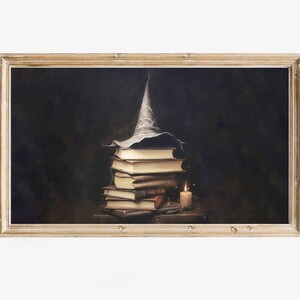 May include: A stack of old, leather-bound books with a pointed, white witch's hat on top. A lit candle sits on a wooden table next to the books.