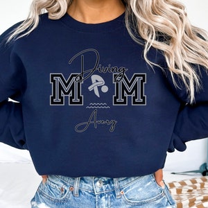 Navy colored sweatshirt featuring the phrase "Diving Mom " and illustrated with a diver. Includes a place to add your diver's name