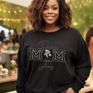 Black colored sweatshirt featuring the phrase "Diving Mom " and illustrated with a diver. Includes a place to add your diver's name