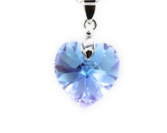 May include: A silver chain necklace with a light blue crystal heart pendant.