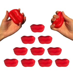 May include: Ten red, soft, squishy lips shaped stress balls. The stress balls are arranged in a pyramid shape with one at the top and three rows of three below.