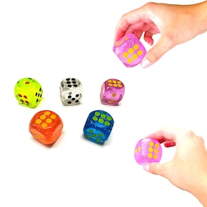 May include: Six colorful dice with black and yellow dots. The dice are made of clear plastic and have a glittery finish. The dice are on a white background.