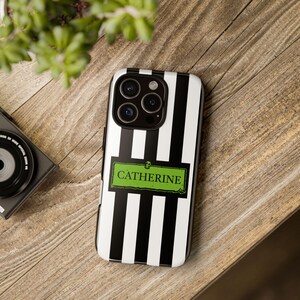 Custom name iPhone, Samsung Galaxy, and Google Pixel phone case inspired by Beetlejuice and Wednesday Addams. Black and white striped design with gothic, alternative, and spooky aesthetic. Perfect personalized gift for Halloween, Christmas, or fans of dark fashion and Tim Burton style.