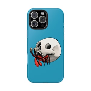 May include: A blue iPhone case with a white skull and a red hermit crab. The skull is facing the left and the crab is crawling into the skull's mouth.