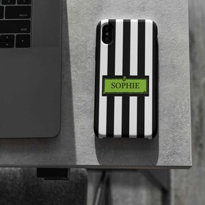 Custom name iPhone, Samsung Galaxy, and Google Pixel phone case inspired by Beetlejuice and Wednesday Addams. Black and white striped design with gothic, alternative, and spooky aesthetic. Perfect personalized gift for Halloween, Christmas, or fans of dark fashion and Tim Burton style.
