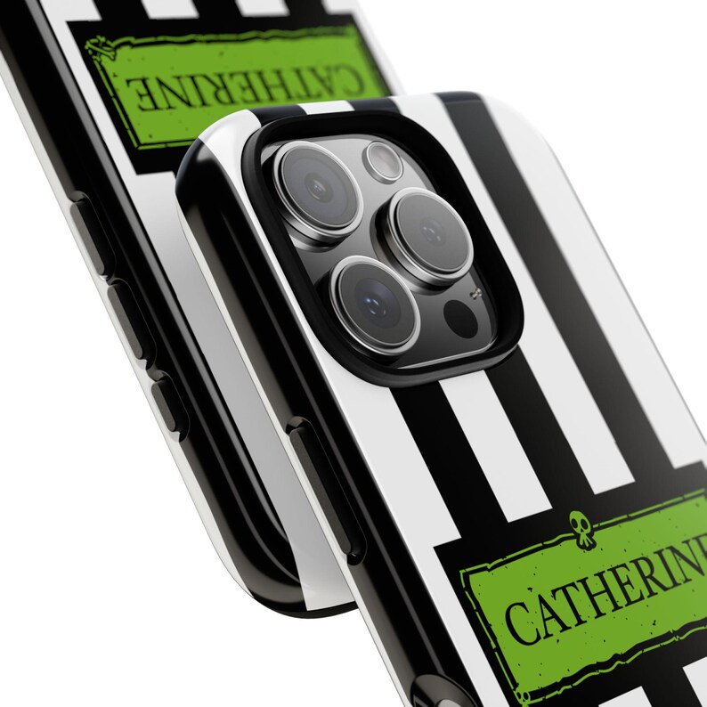 Close-up of custom name iPhone, Samsung Galaxy, and Google Pixel phone case inspired by Beetlejuice and Wednesday Addams. Black and white striped design with gothic, alternative, and spooky aesthetic. Perfect personalized gift for Halloween, Christmas, or fans of dark fashion and Tim Burton style.