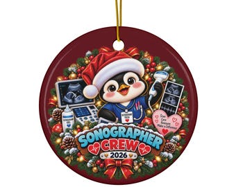 May include: A round ceramic ornament featuring a penguin wearing a Santa hat and blue scrubs, holding an ultrasound probe. The design includes a Christmas wreath, ultrasound equipment, and the text Sonographer Crew 2026.