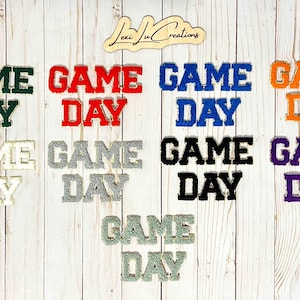 May include: Eight iron-on patches with the text "GAME DAY" in different colors, including green, red, blue, orange, silver, black, purple, and white.