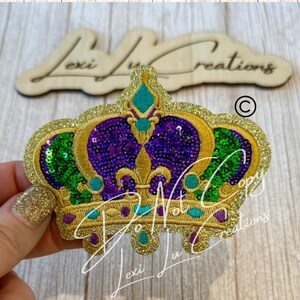 May include: Embroidered crown patch with gold, purple, green, and teal sequins. The crown features a fleur-de-lis design and is embellished with gold glitter. The text "Don't Copy" and "Lexi Lu Creations" are visible.