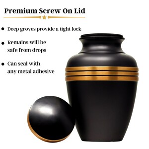 May include: Black urn with gold trim and a matching screw-on lid. The urn has a smooth, polished finish.  "Premium Screw On Lid" is written at the top of the image.  "Deep grooves provide a tight lock" is written below the title.  "Remains will be safe from drops" is written below that.  "Can seal with any metal adhesive" is written below that.