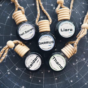 May include: A set of three ceramic mugs with a speckled, matte finish. Each mug features a different color: light blue, cream, and gray. The mugs have a simple, modern design with a rounded shape and a comfortable handle.