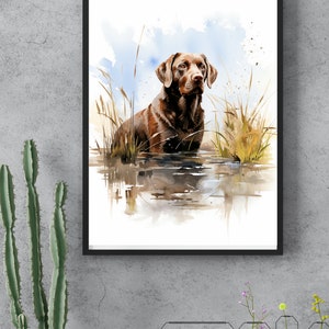 May include: Watercolor painting of a brown Labrador Retriever standing in a pond with tall grass. The dog is looking to the right of the image. The background is a light blue watercolor wash.